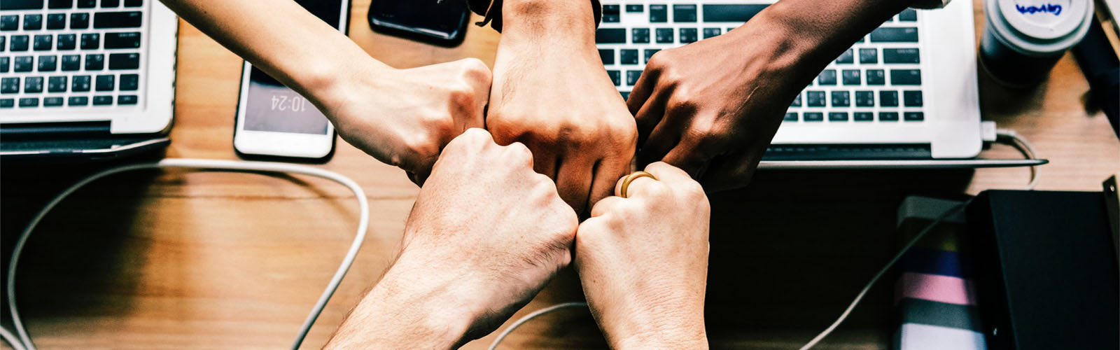 Office workers putting hands together
